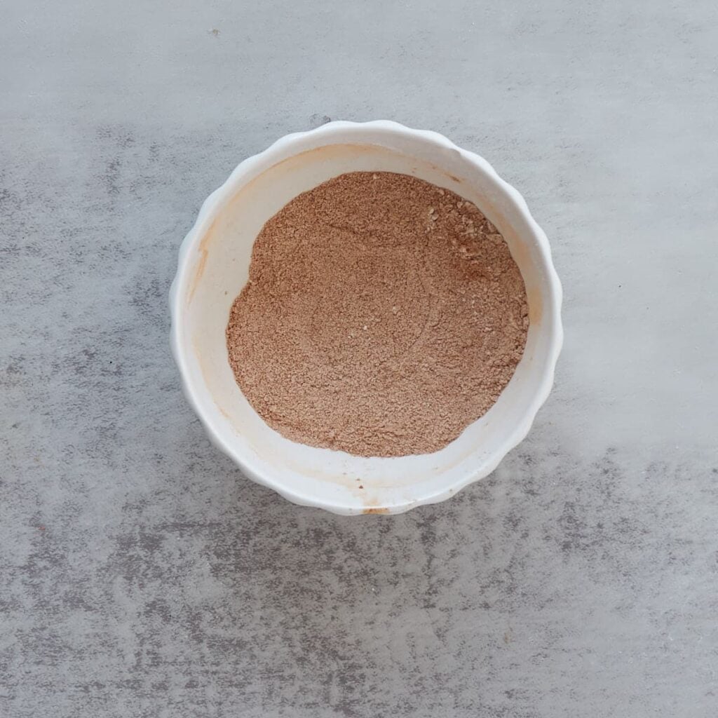 Cinnamon sugar filling mixed together in a small white bowl.
