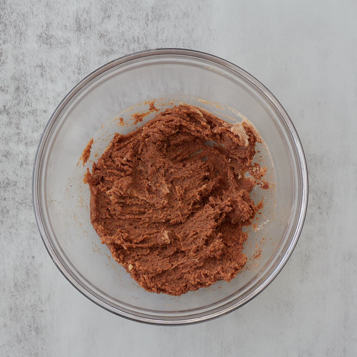 Cinnamon, softened butter, and brown sugar mixed in a clear bowl.