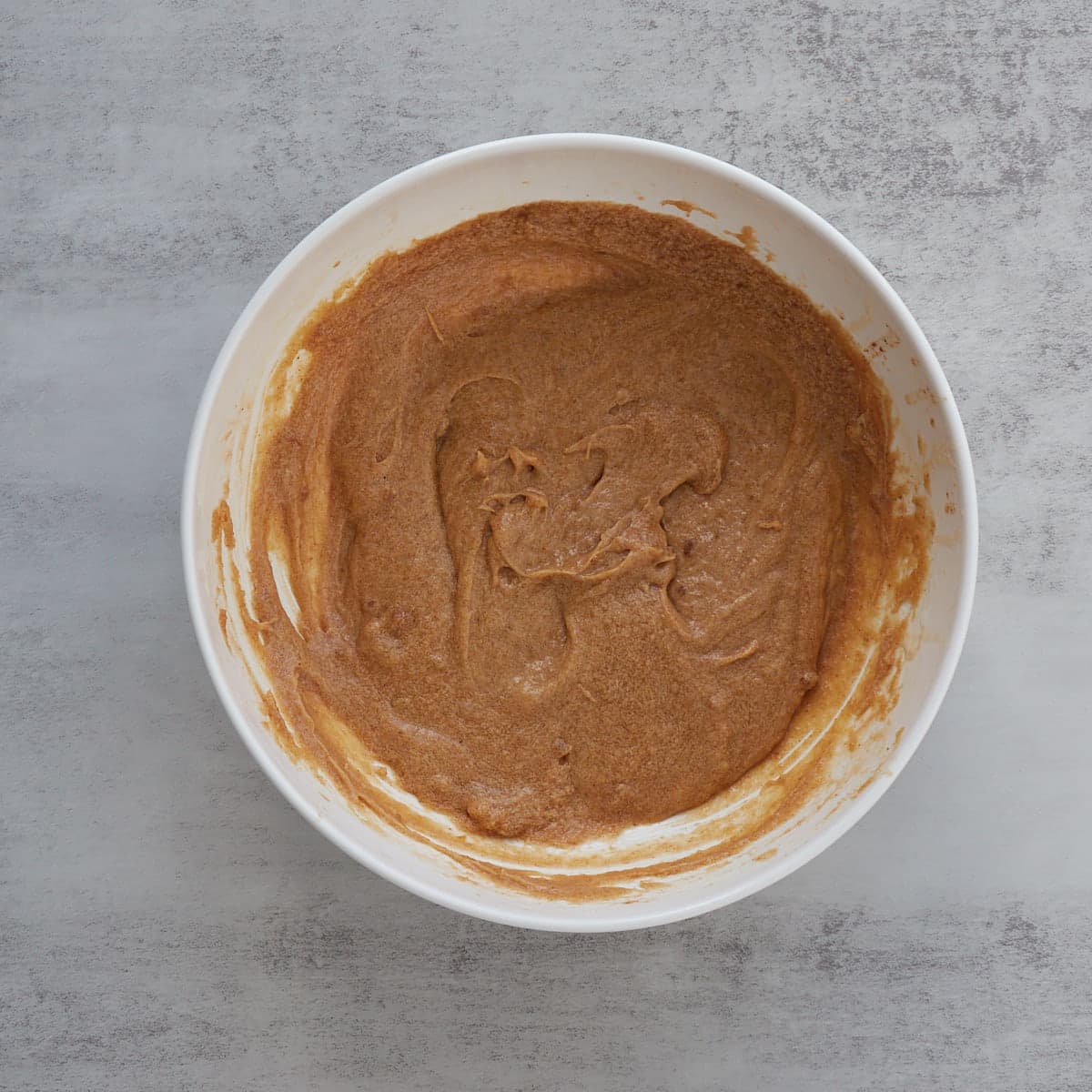 An egg, sourdough discard, and vanilla added to the browned butter and brown sugar in a large mixing bowl.