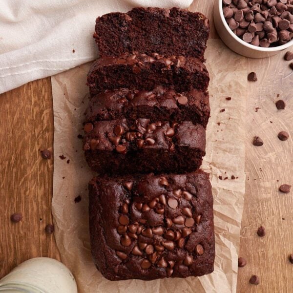 Sourdough Chocolate Banana Bread on brown parchment paper next to a small bowl of chocolate chips.