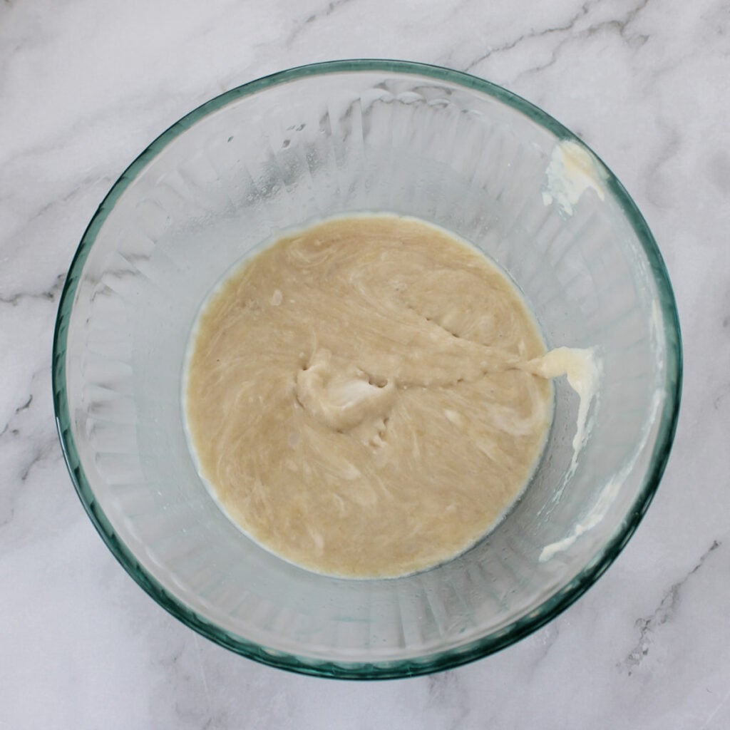 Wet ingredients for sourdough granola in a clear bowl.