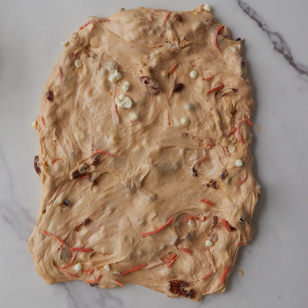 Carrot Cake Sourdough Bread dough pulled out into a rectangle for shaping.
