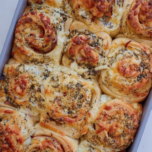 Freshly baked Sourdough Ham and Cheese Rolls in a 9x13 pan.
