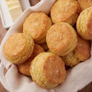Sourdough Buttermilk Biscuits stacked in a basket.