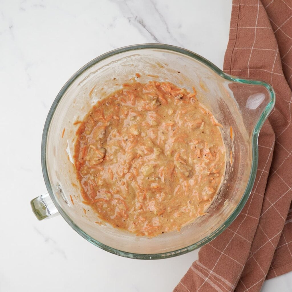 Carrots, crushed pineapple and nuts folded into batter for sourdough carrot cake.