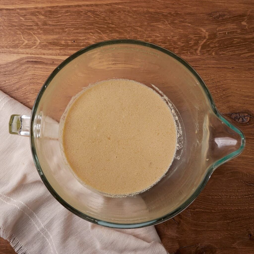 Wet ingredients added in a clear bowl for Sourdough Chocolate Banana Bread.