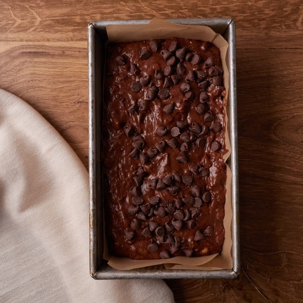 Batter for Sourdough Chocolate Banana bread added to a loaf pan.