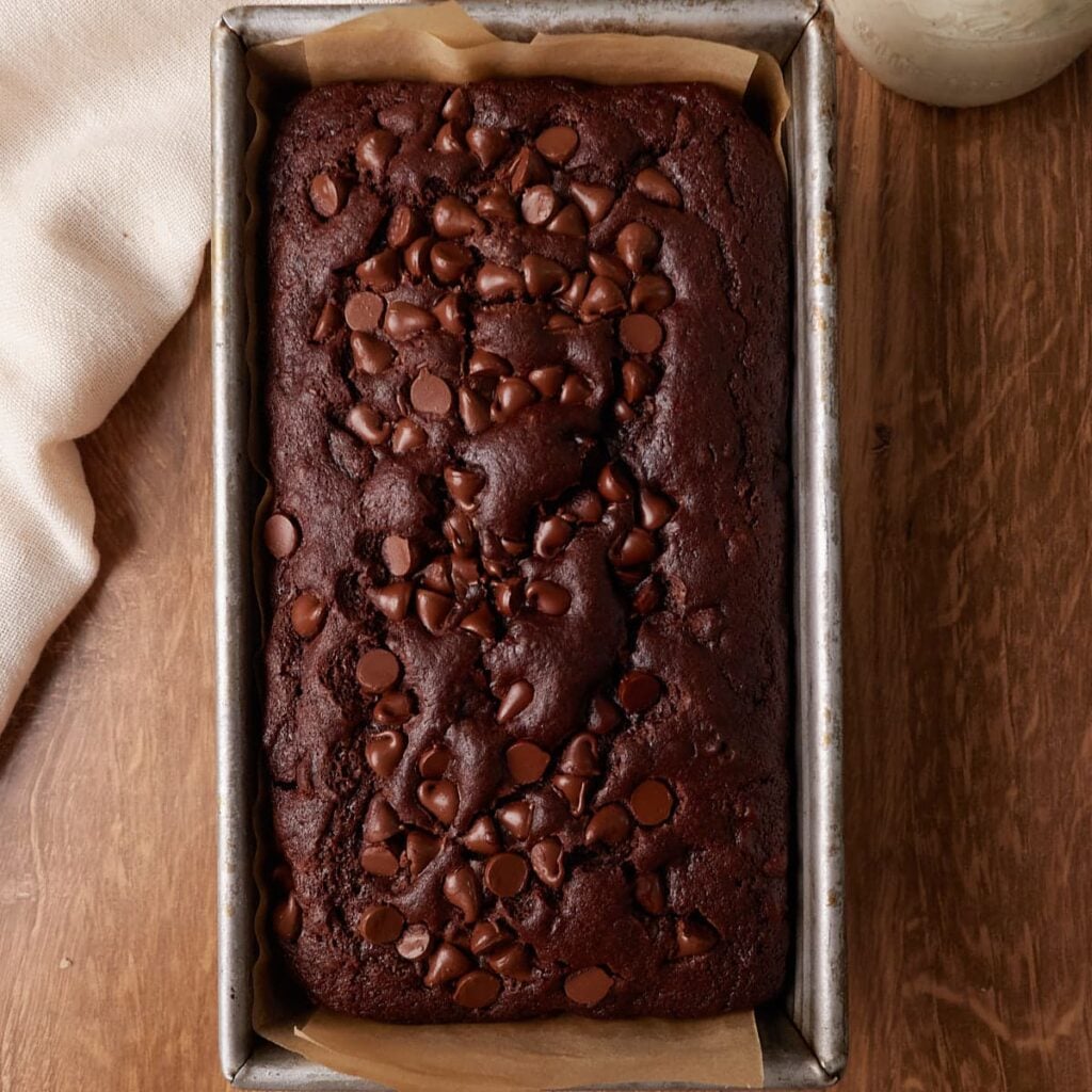 Freshly baked Sourdough Chocolate Banana bread in a loaf pan.