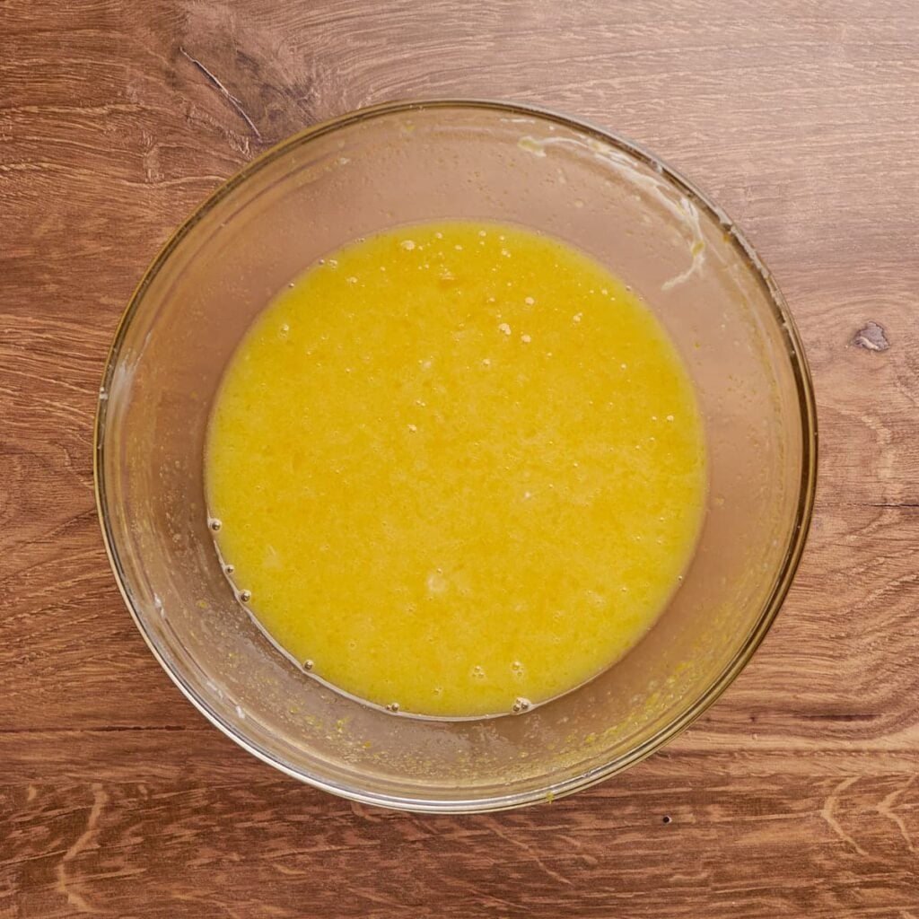 Filling for sourdough lemon bars mixed in a clear bowl.