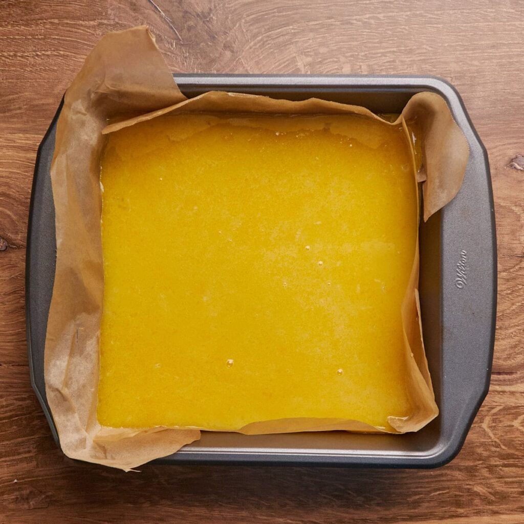 Filling added on top of baked shortbread crust of sourdough lemon bars.