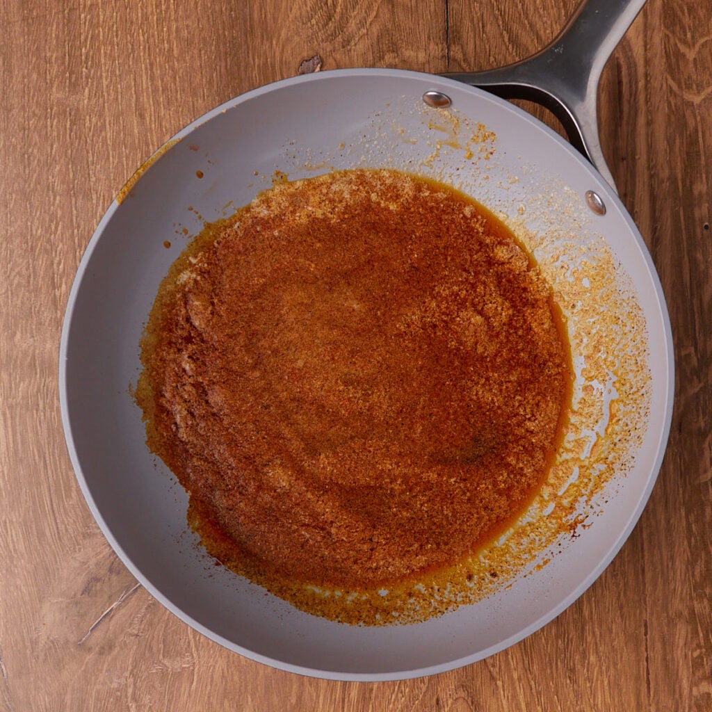 Butter and spices in a small pan for sourdough pan and cheese.