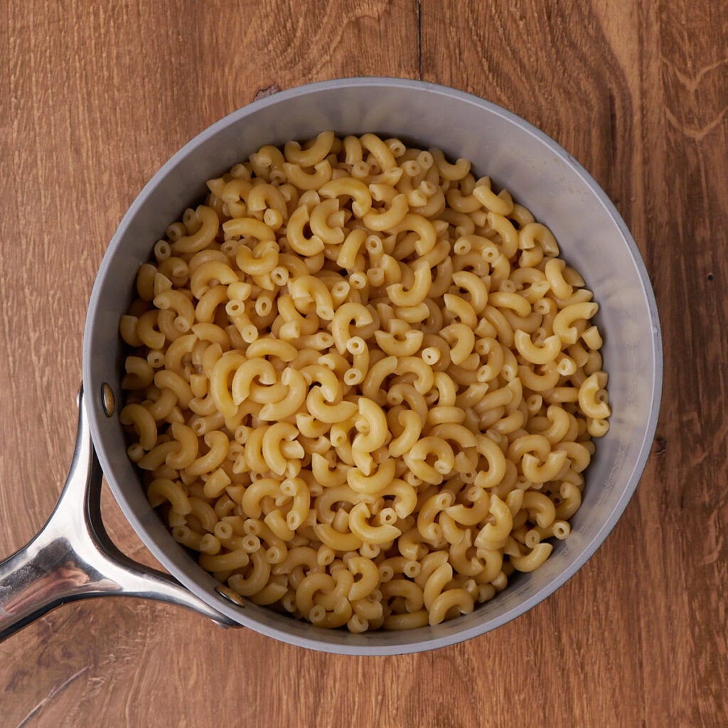 Cooked elbows noodles in a pot for sourdough mac and cheese.