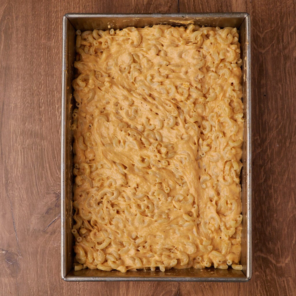 Sourdough mac and cheese added to a 9x13 pan.