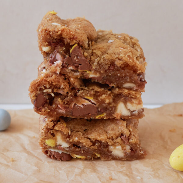 Three Cadbury Egg Sourdough Cookie Bars stacked on top of each other.