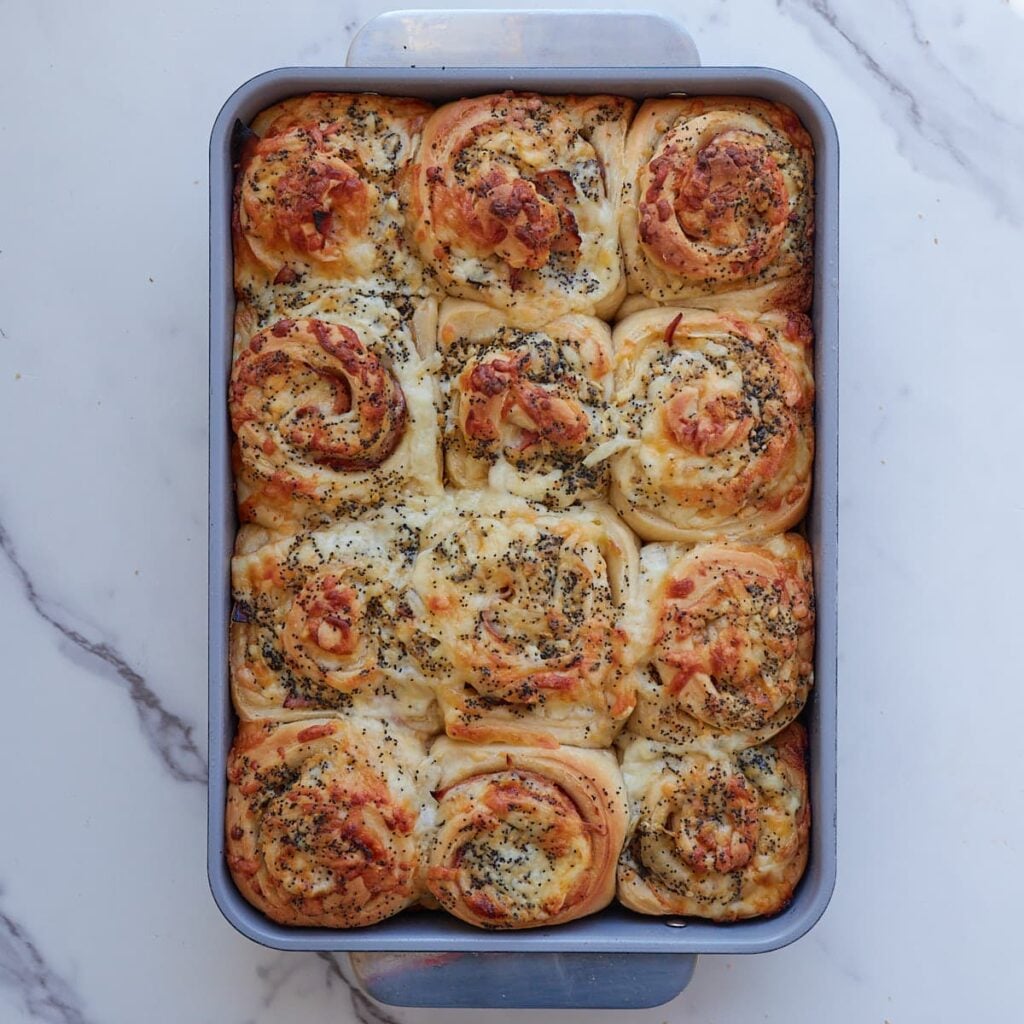Freshly baked Sourdough Ham and Cheese Rolls in a 9x13 pan.