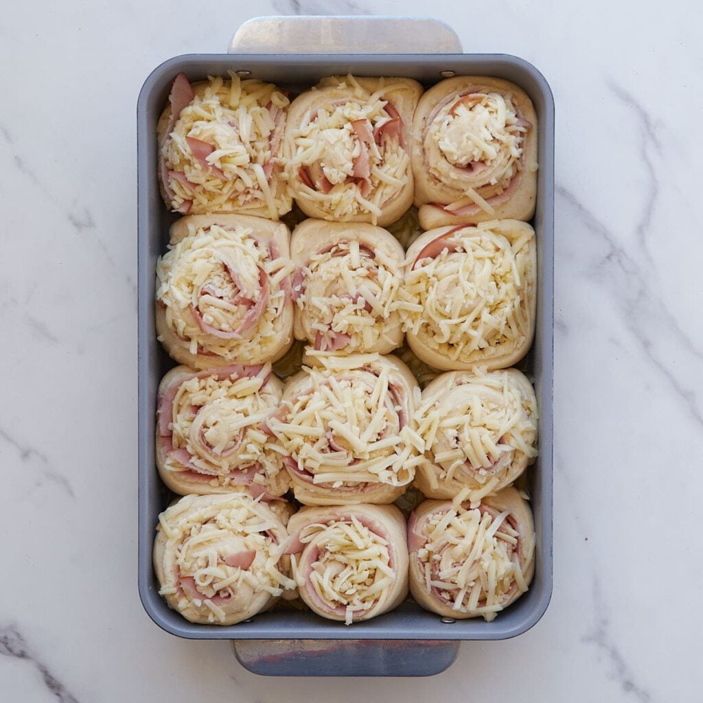 Sourdough Ham and Cheese Rolls in a 9x13 pan after the second rise.
