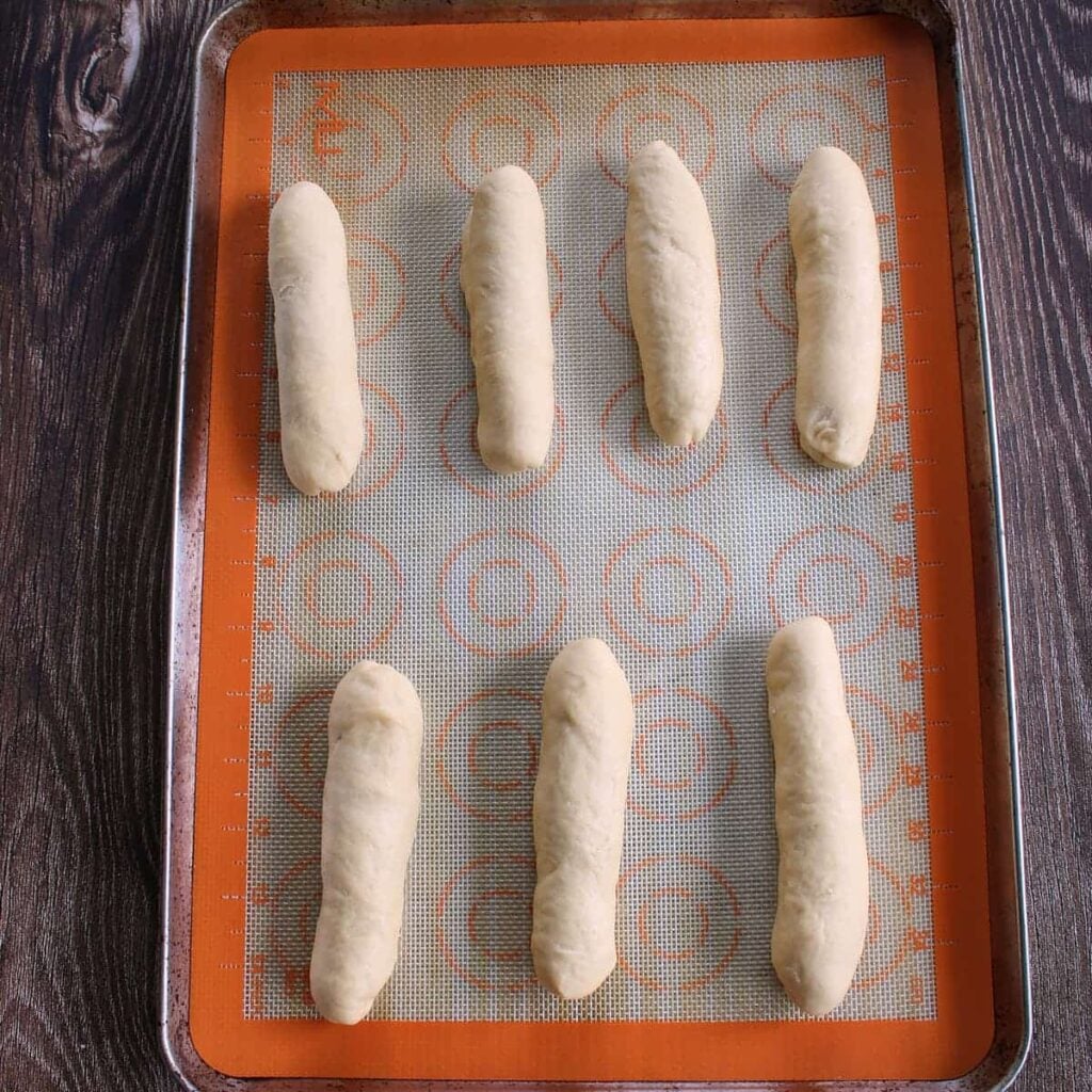 Sourdough discard hot dog bun dough on a sheet pan before the 1 hour rise.
