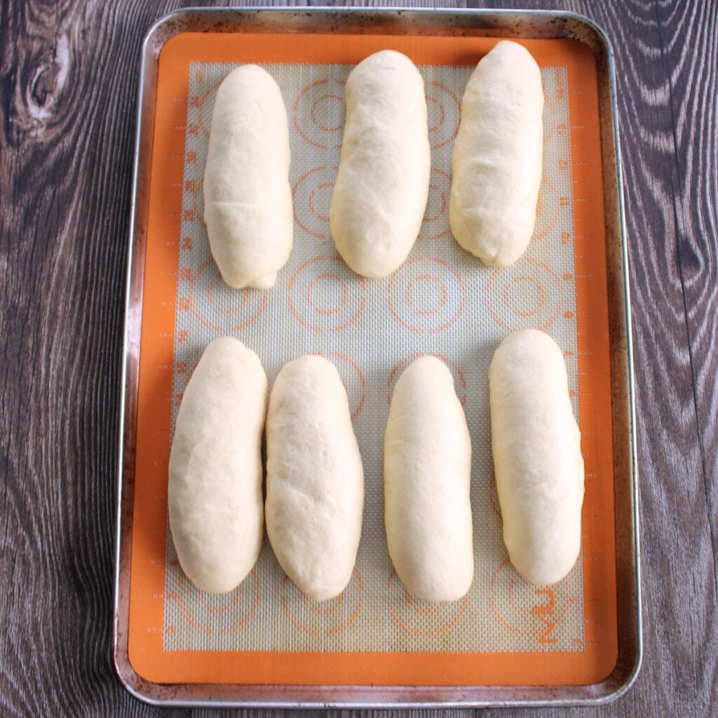 Sourdough discard hot dog bun dough on a sheet pan after the 1 hour rise.