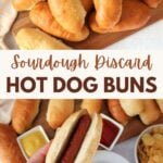 A hand holding a sourdough discard hot dog bun with a hot dog inside and sourdough discard hot dog buns on a wooden cutting board.