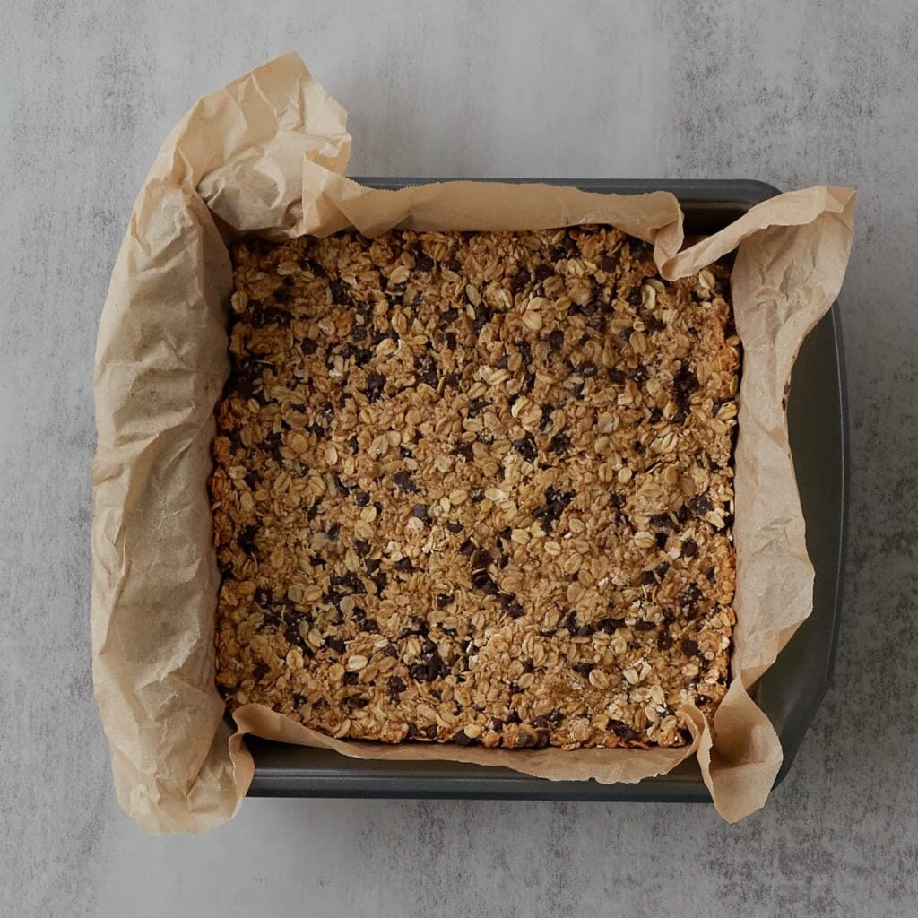 Freshly baked sourdough granola bar in a 9x9 baking pan.