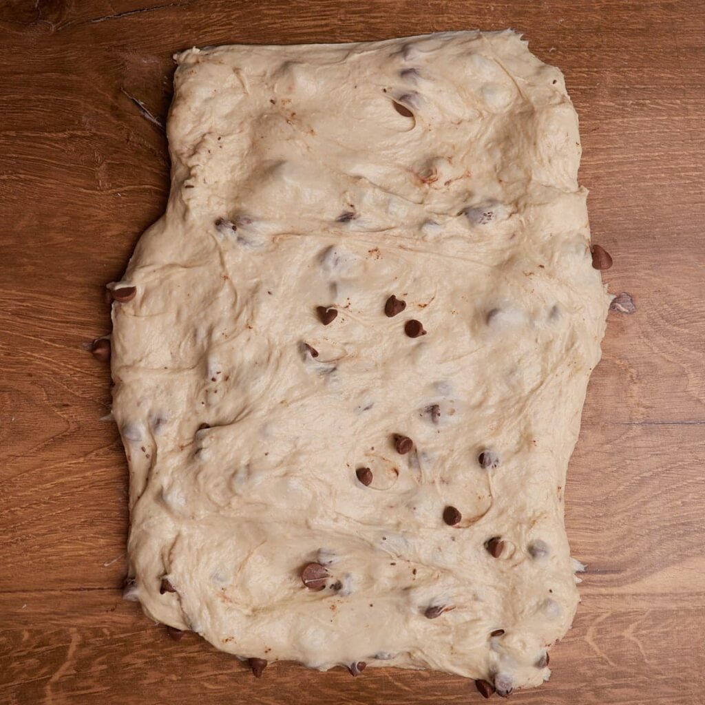 Dough for S'mores Sourdough Bread spread out into a cubby rectangle.