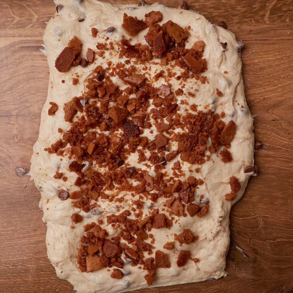 Adding the butter and graham crackers while shaping the dough for S'mores Sourdough Bread.