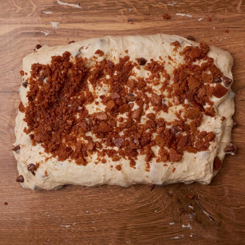 Adding the butter and graham crackers while shaping the dough for S'mores Sourdough Bread.