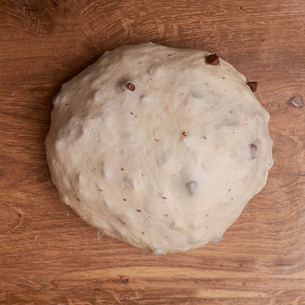 Shaping the dough for S'more Sourdough Bread into a round shape.