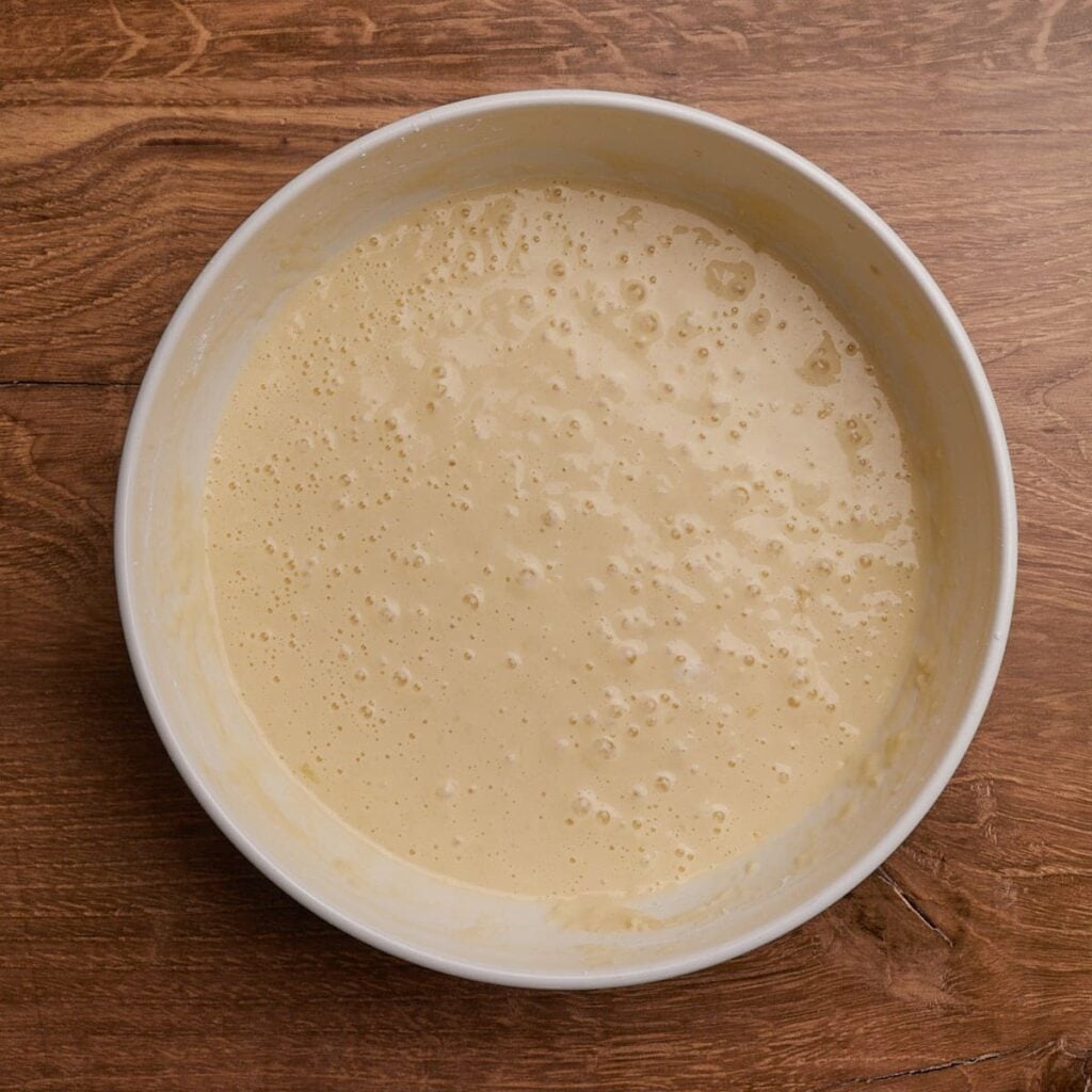 Sourdough waffle batter in a white bowl.