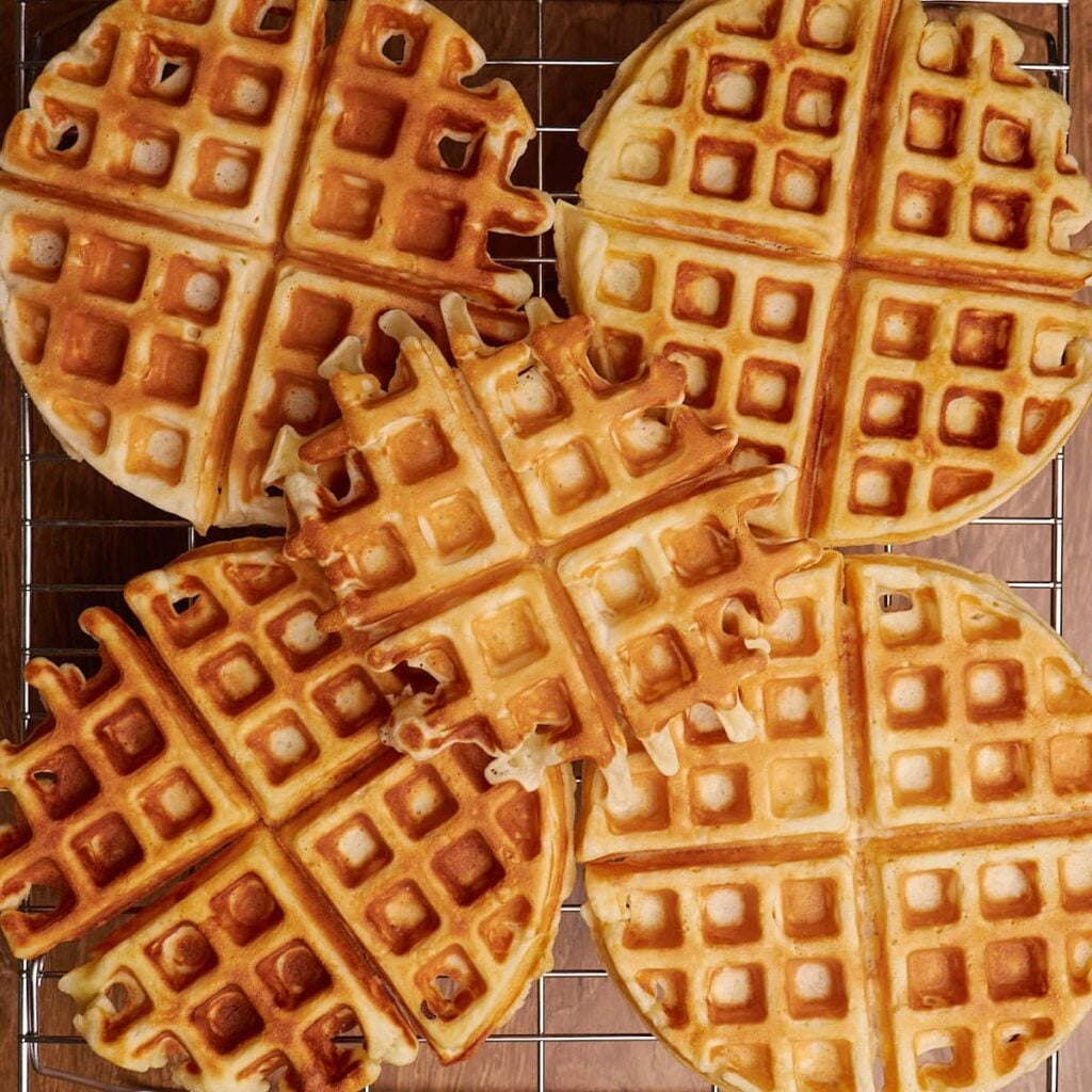 5 Sourdough waffles on a cooling rack.