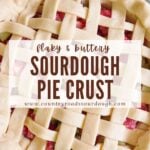 Sourdough pie dough in a lattice top next to a green cloth napkin and with strawberry rhubarb filling.