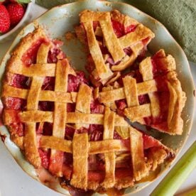 Sourdough Strawberry Rhubarb Pie cut into slices in a pie pan.