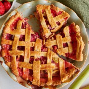 Sourdough Strawberry Rhubarb Pie cut into slices in a pie pan.