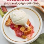 A slice of sourdough strawberry rhubarb pie with ice cream on top of a white plate.
