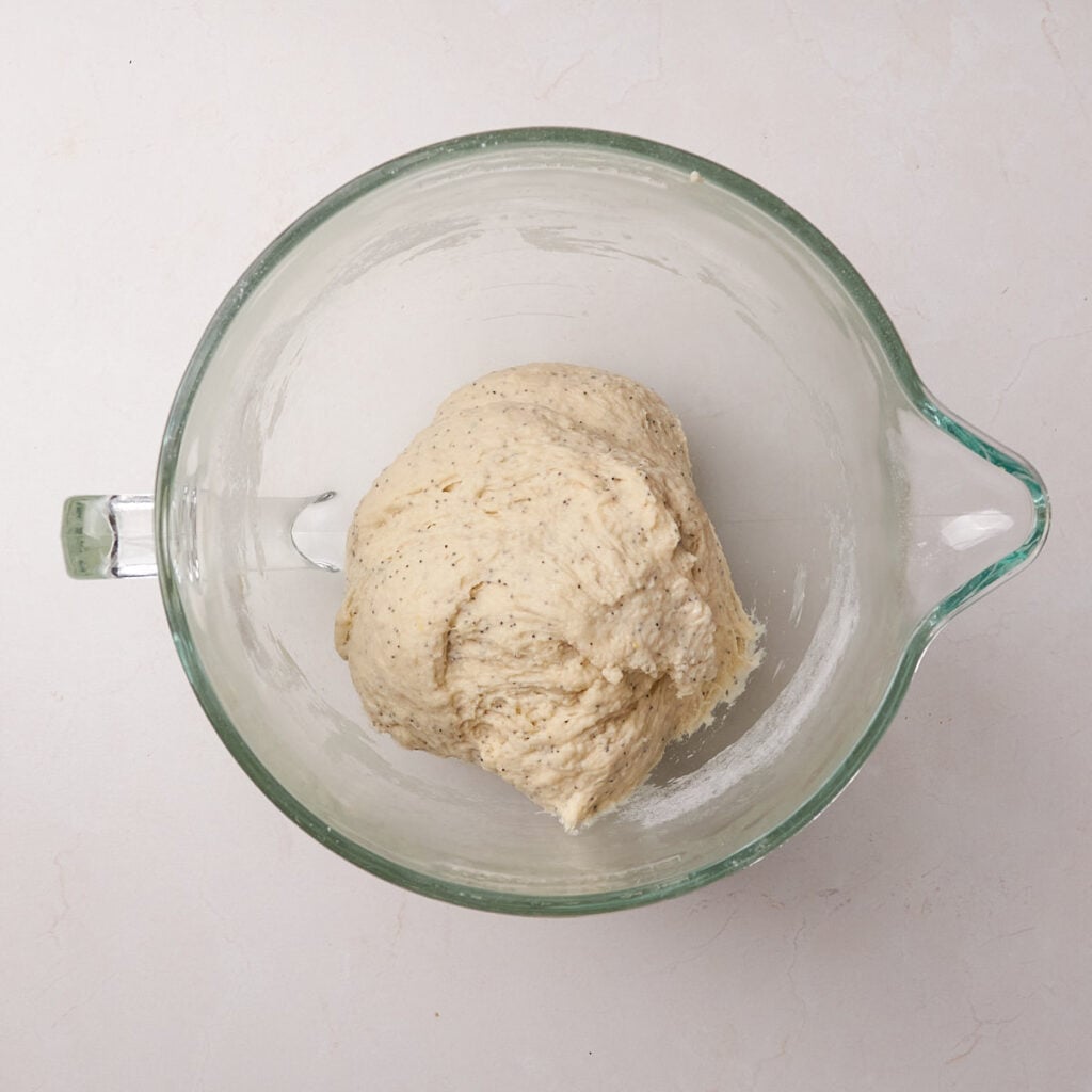 Dough for Lemon Blueberry Sourdough Rolls in a clear bowl before the first rise.