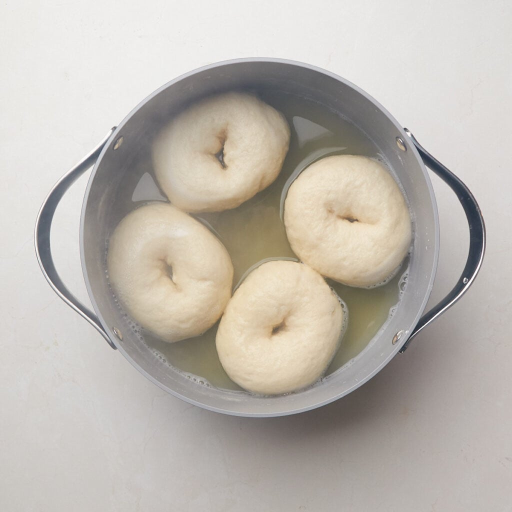 Sourdough discard bagels in boiling water with baking soda.