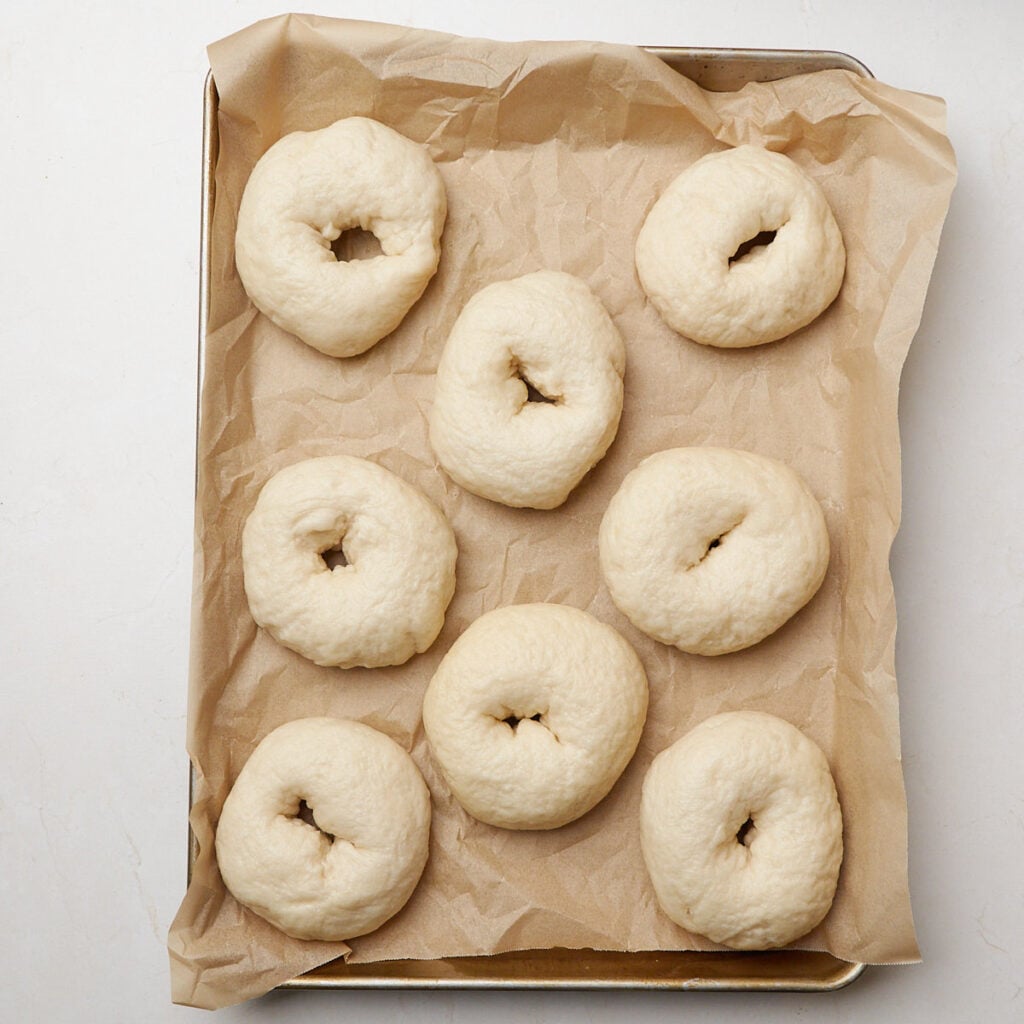 Sourdough discard bagels on a sheet pan for baking.