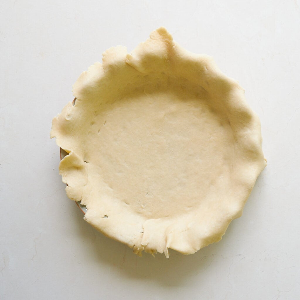 Sourdough pie dough pressed into a pie pan.