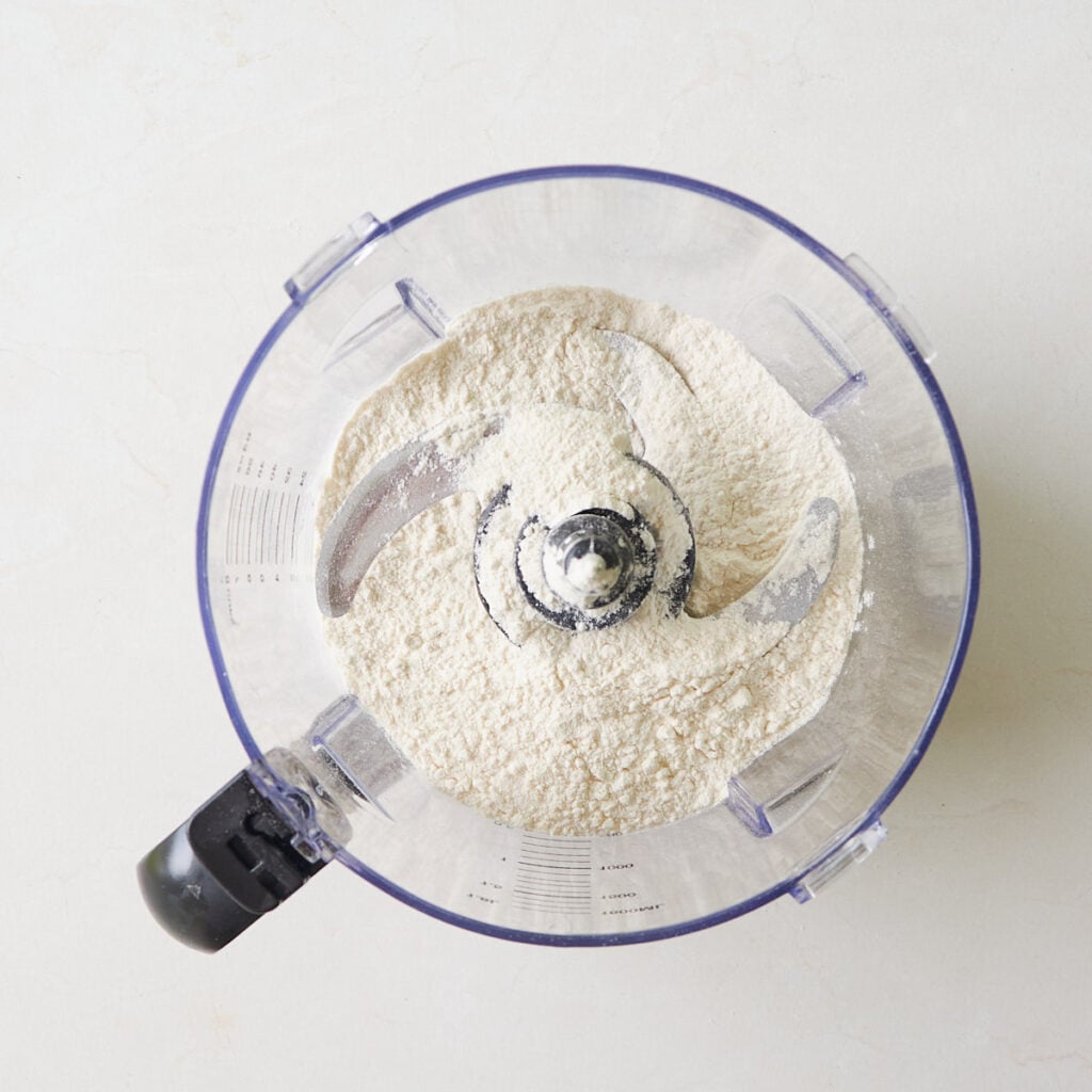 Flour, sugar and salt added to a food processor to make sourdough pie crust.