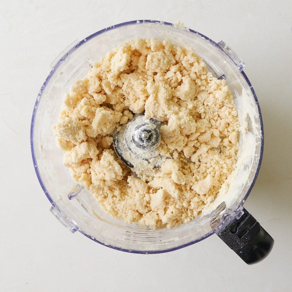 Dough for sourdough discard pie crust in a food processor after all ingredients are mixed together.