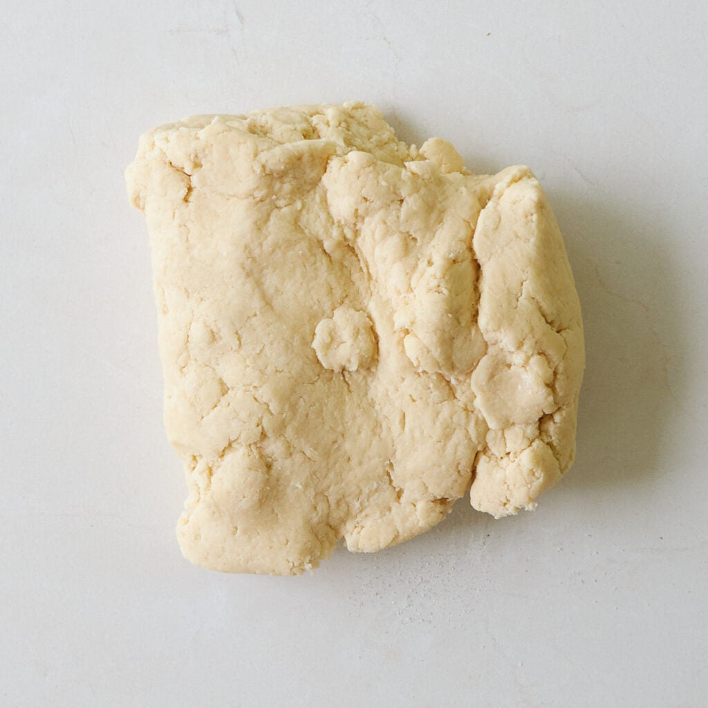 Sourdough pie dough on a white surface. 