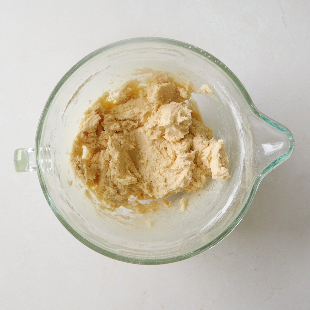 Dry ingredients added to wet ingredients for Sourdough Sprinkle Cookies.