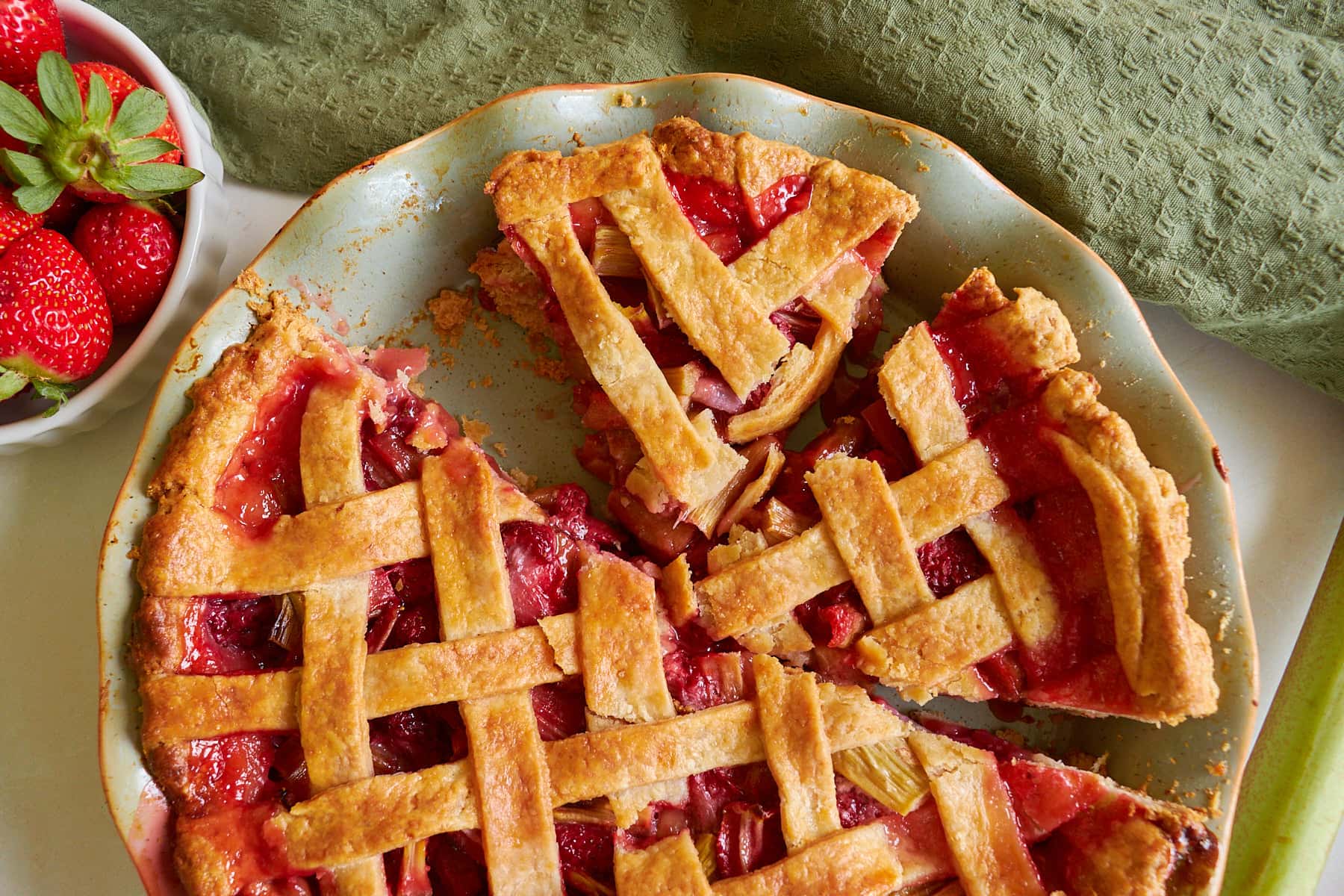 Strawberry Rhubarb Pie made with sourdough pie crust cut into slices in a pie pan.