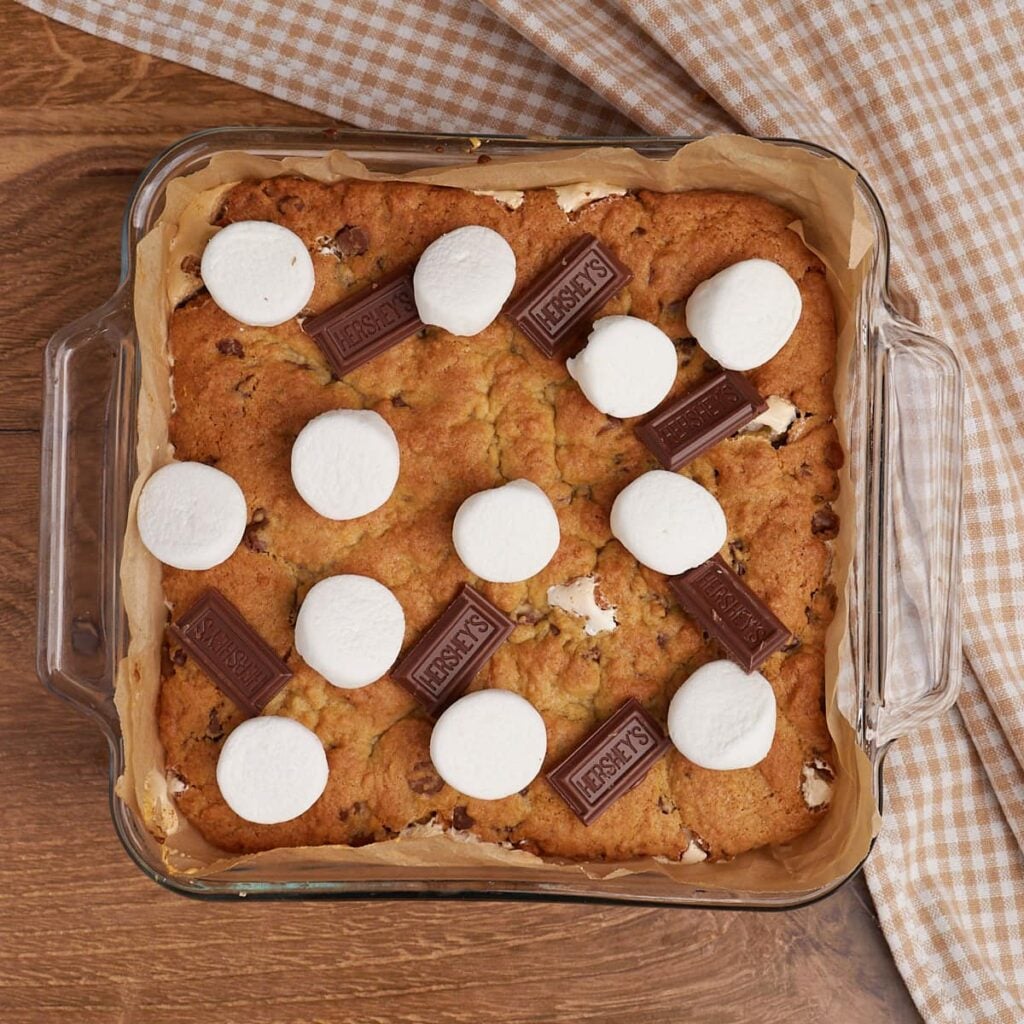 Freshly baked Sourdough S'mores Cookie Bars with marshmallows and chocolate squares added on top.
