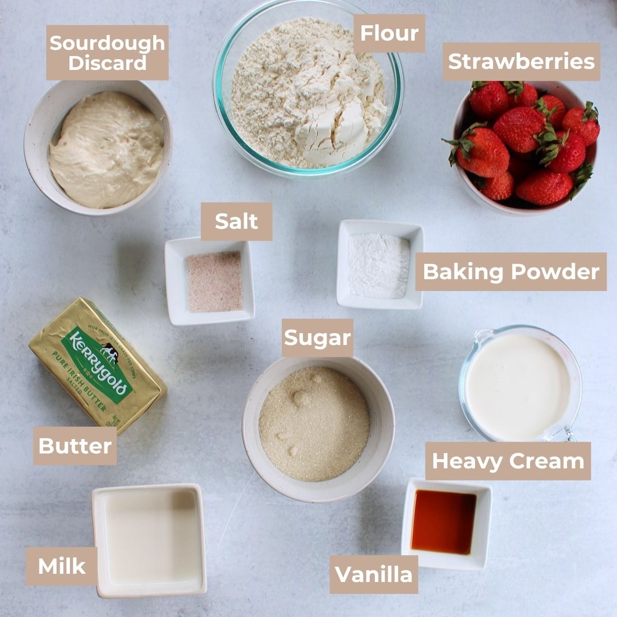 Ingredients for Sourdough Strawberry Shortcake in white and clear bowls on a white background.