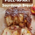 Sourdough Peach Pull-Apart Bread on brown parchment paper with a piece pulled off.