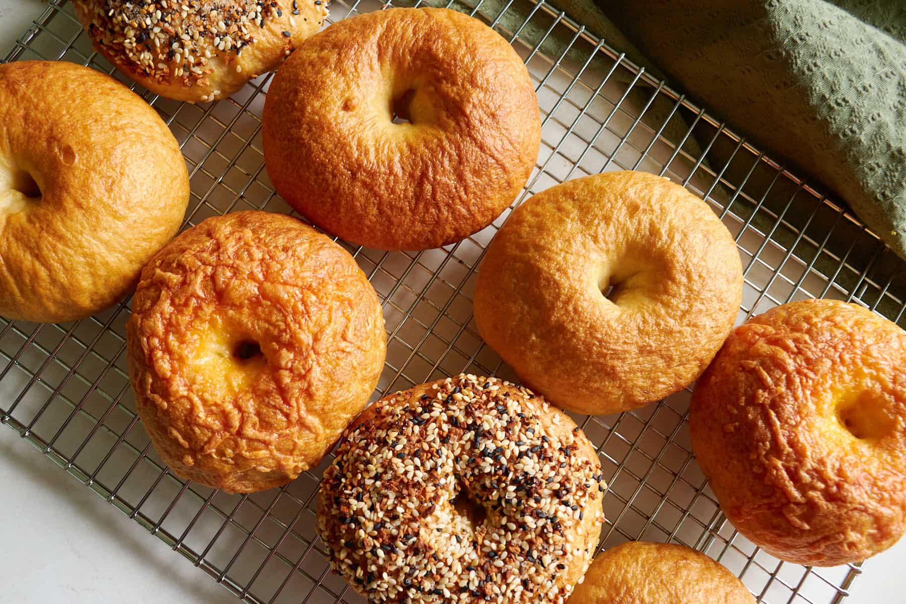 Sourdough discard bagels on a wire cooling rack.