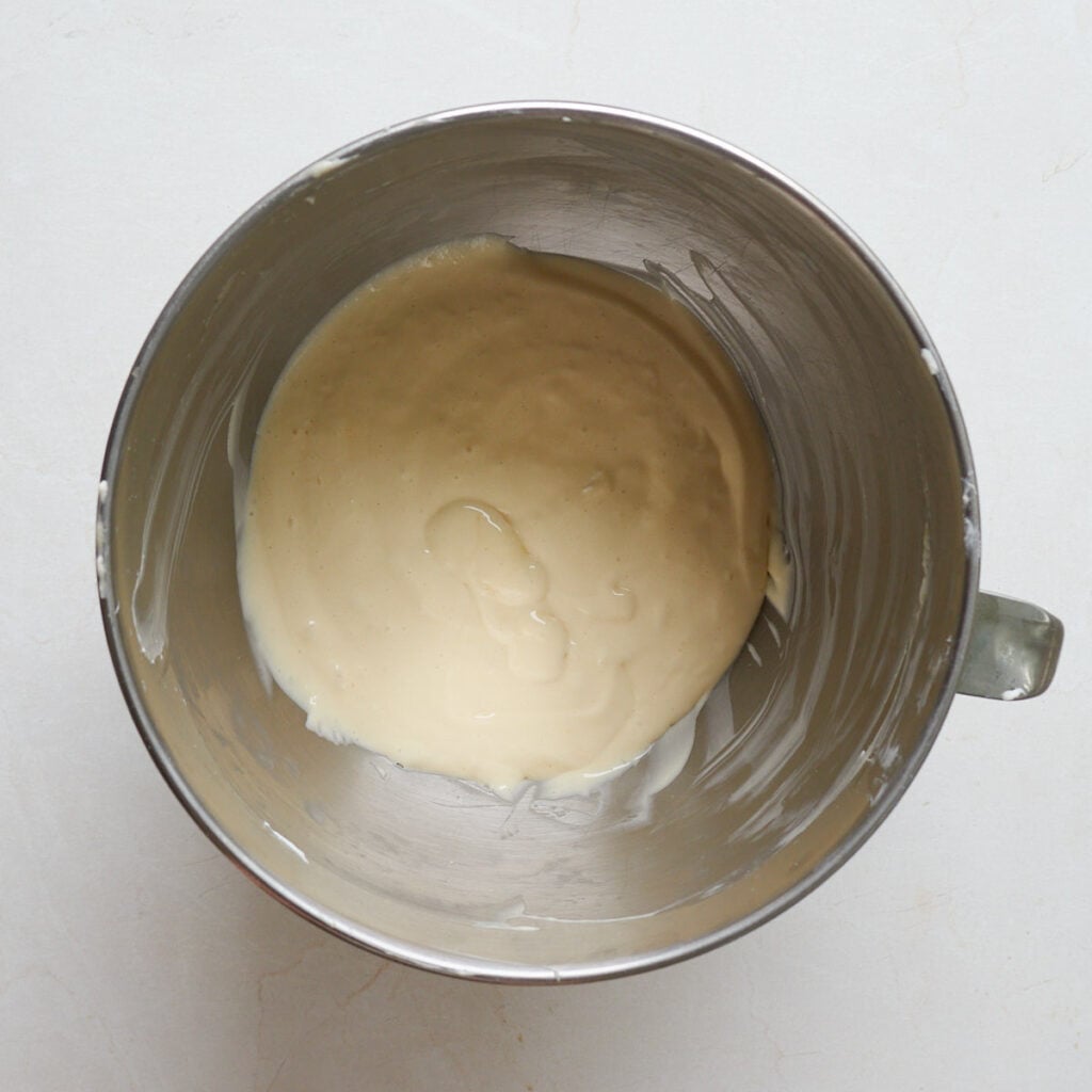 Cheesecake layer for Sourdough Peach Crumble Cheesecake Bars mixed in a metal mixing bowl.