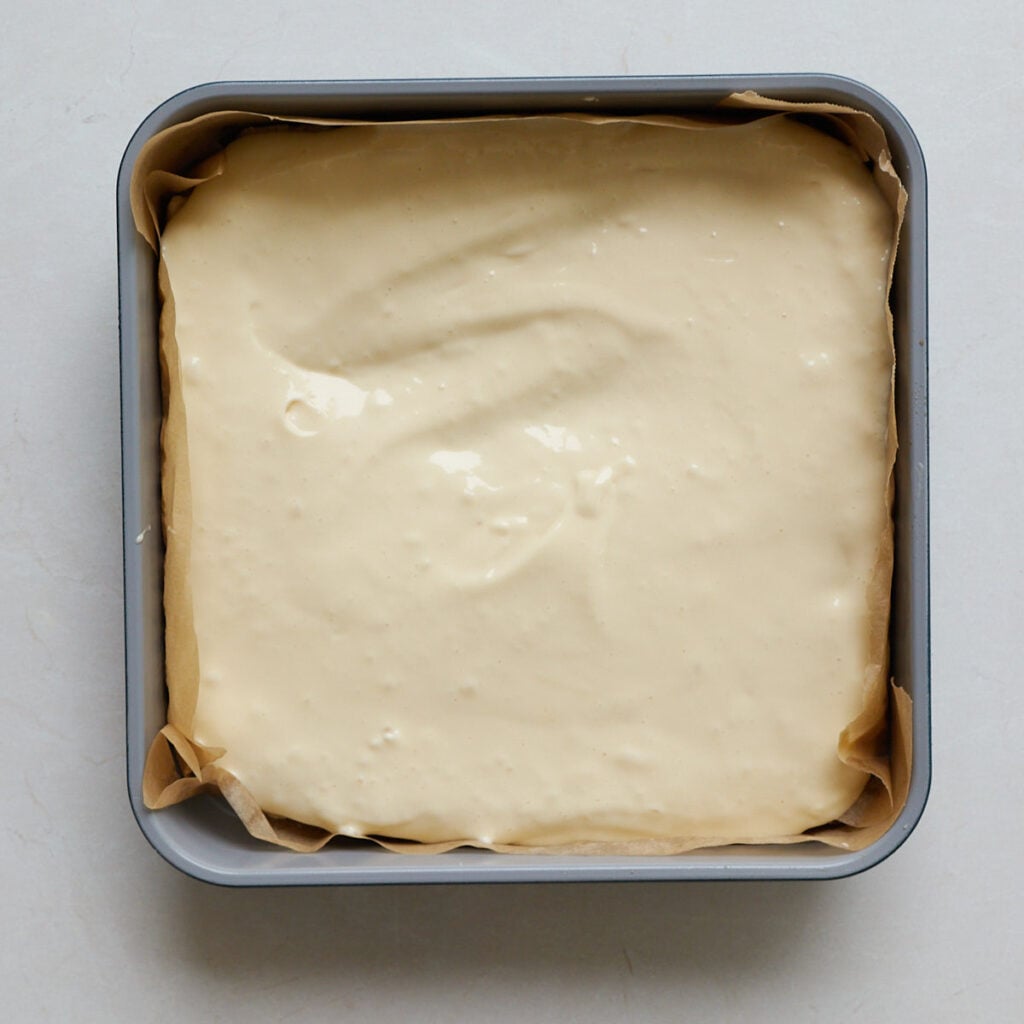Cheesecake layer added for Sourdough Peach Crumble Cheesecake Bars in a 9x9 baking pan.