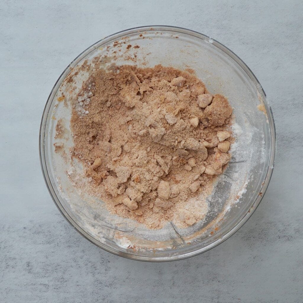 Streusel topping mixed together in a small clear bowl for Sourdough Peach Pull-Apart Bread.